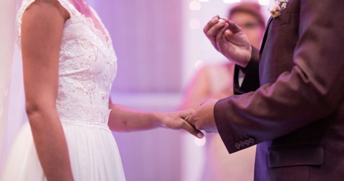 Person Holding Ring While Holding Woman's Hand Using Left Hand