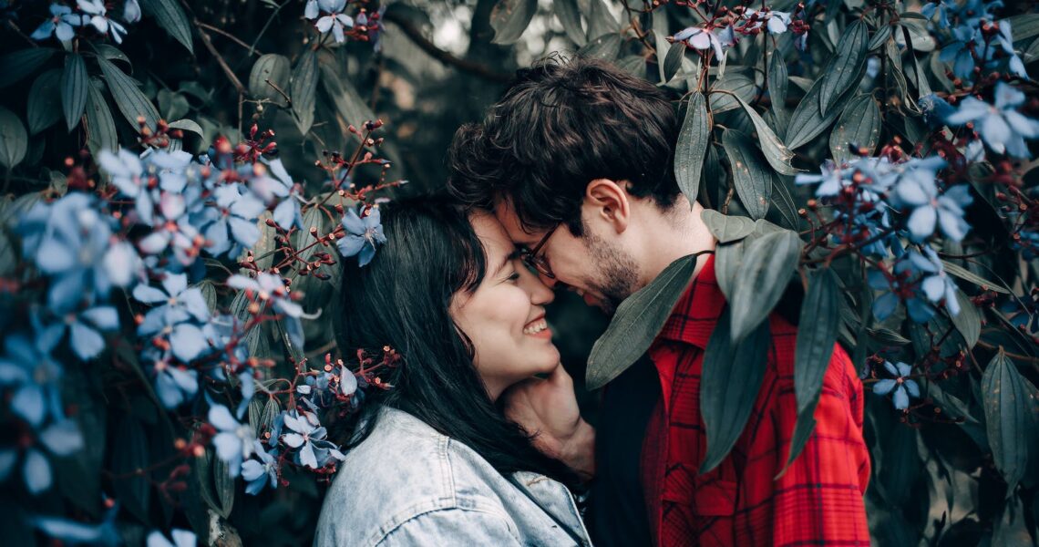 Man and Woman Standing Under Flowering Tree