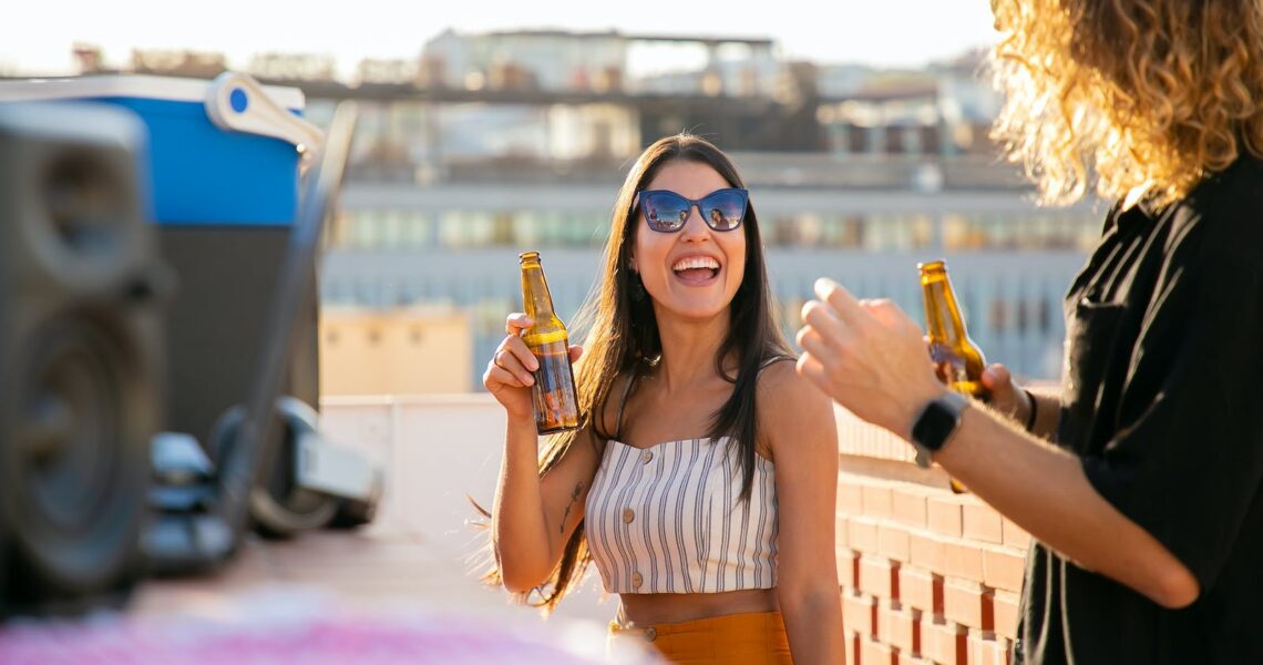 Smiling Woman Holding a Beer Bottle