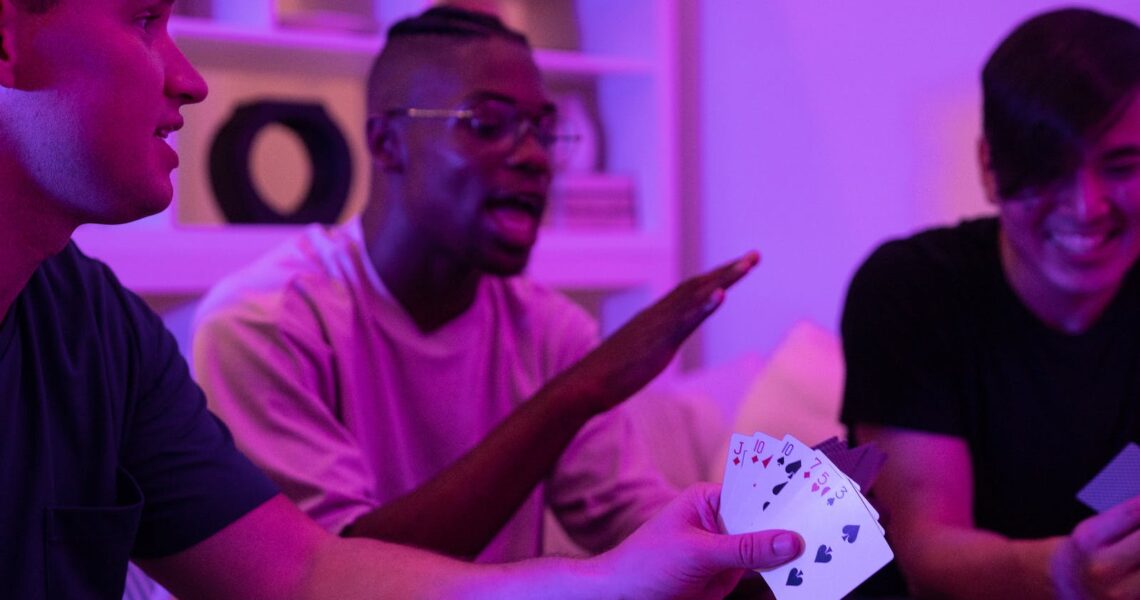 A Man Holding a Set of Playing Cards