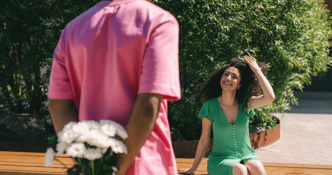 A Man Surprising a Woman with a Bouquet of Flowers